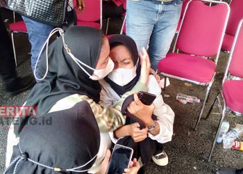 Wartawan lain mencoba menenangkan Zaskia, korban pencopetan saat meliput Presiden Jokowi di Pasar Peterongan, Kota Semarang. (Adimungkas/Koran Lingkar)